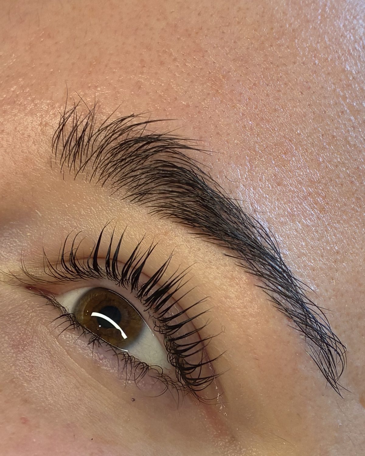 Close-up of a finished lash lift — lashes curled up and separated
